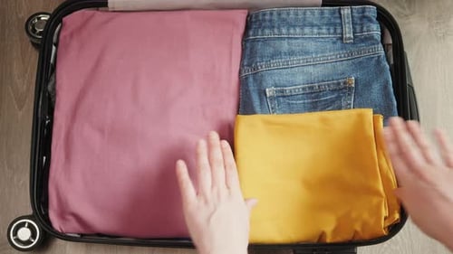 Packing Clothes and Accessories Into a Suitcase