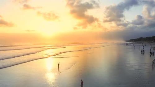 People on the Seminyak Beach at Sunset Over the Ocean. Aerial View