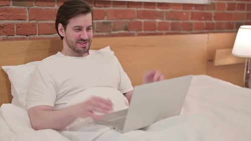 Man in Bed Using Laptop on Video Call