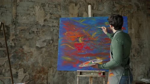Focused Painter Creating Abstract Art in Studio