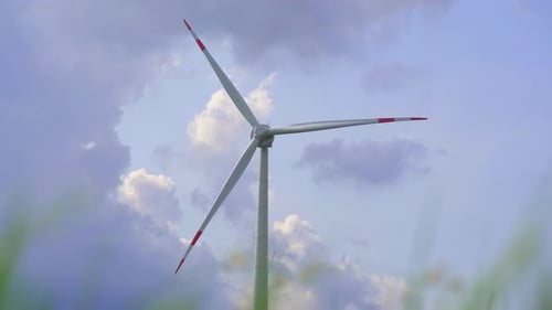 Wind Turbine Rotating Under Blue Sky