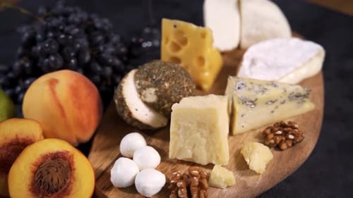 Delectable Cheese and Fruit Selection on Wooden Board