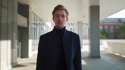 Blond Man Walking Towards Camera in City