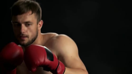 Muscular Boxer in Red Gloves Sparring Close Up