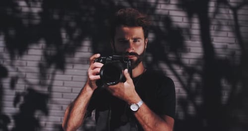 Photographer focuses and snaps image of subject