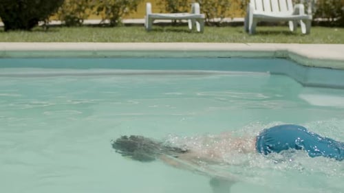 Cheerful Boy in Watersport Goggles Swimming Underwater