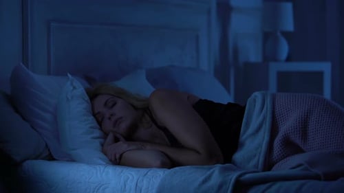 Woman Lying Awake, Restless in Her Bed at Night