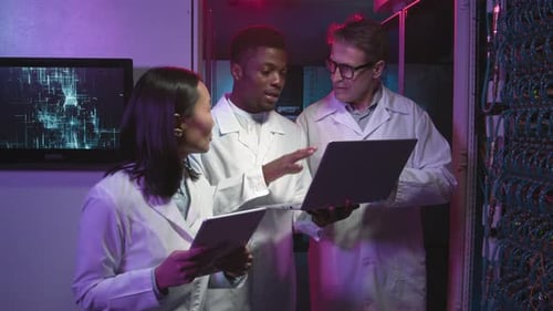 Team of IT Specialists Discussing Work and Posing in Data Center