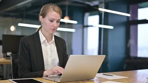 Sick Young White Businesswoman Coughing in Office