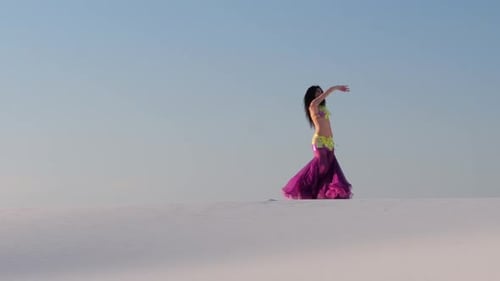 Girl Dances Belly Dancing in the Sandy Desert, Her Movements Are Unique