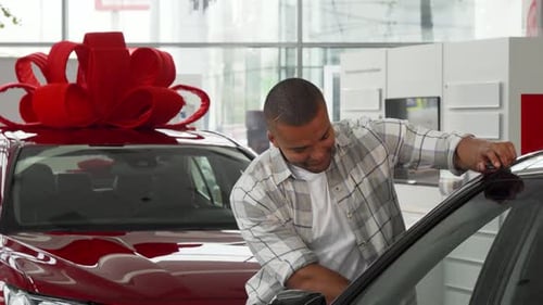 Man Smiling, Leaning on New Car Holding Keys