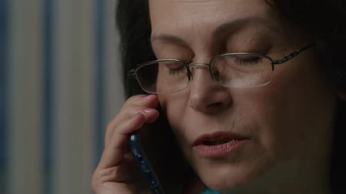 Woman Speaks on Mobile Phone in Close Up
