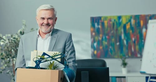 Man Holding Belongings Leaving Office Workplace