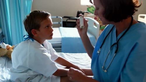 Female doctor helping patient use inhaler