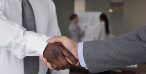 Handshake Between Businessmen in Office Environment