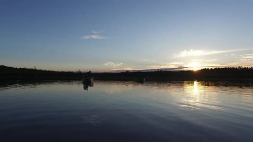 Boat floating on the lake at sunset