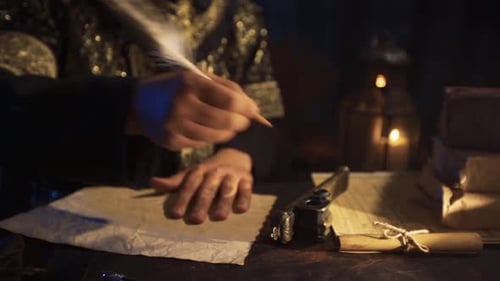 Person Writing with Quill by Candlelight