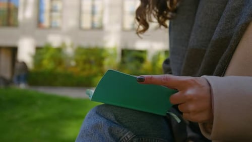 Student Make Paper Notes in Diary on Street
