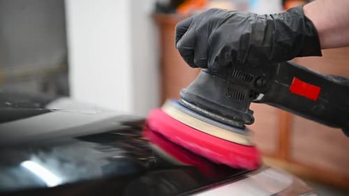 Slow Motion Close Up Polishing the Car with Orbital Polisher Tool in Service. Automotive Detailing