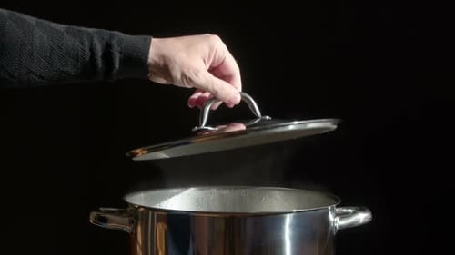 Steam Rises From Cooking Pot With Lid Removed