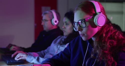 Caucasian woman typing on computer keyboard in a creative office