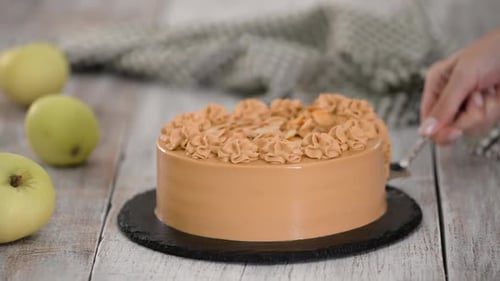 Slicing Caramel Cake on Wooden Table