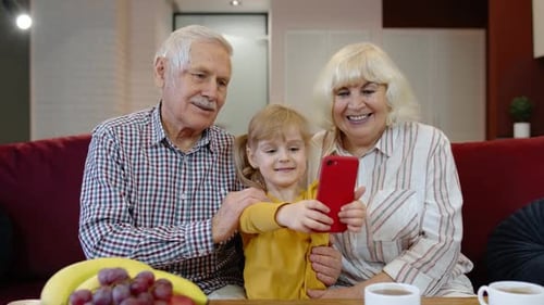 Grandparents Take Photo with Grandchild