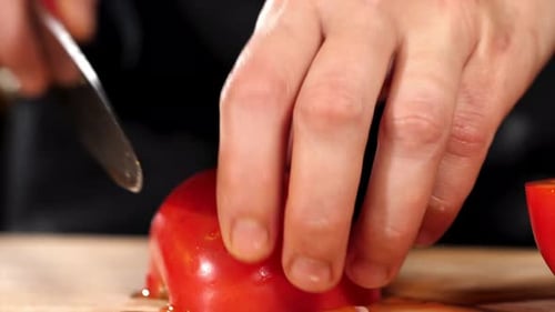 Slicing a Ripe Red Tomato With Sharp Knife
