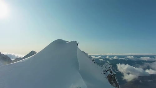 Snow-Capped Mountain in European Alps in Sunny Day. Aerial View
