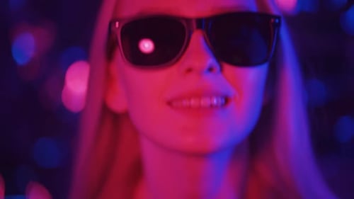Blonde Woman Wearing Sunglasses in Blue and Pink Light
