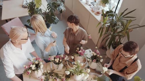 Team of Florists Making Bouquets at Table in Flower Shop