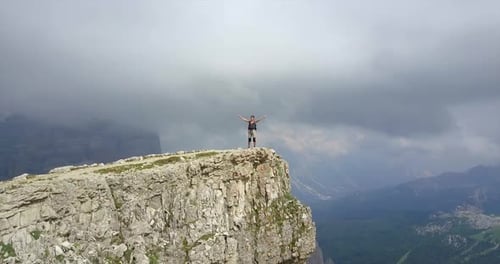 Aerial drone view of a woman hiking in the mountains.