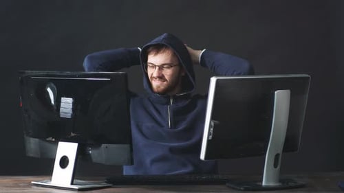 IT Professional Programmer Is Working on Computer in Dark Office Room