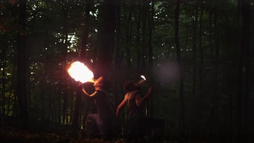 Men Fire Breathing at Night in the Forest