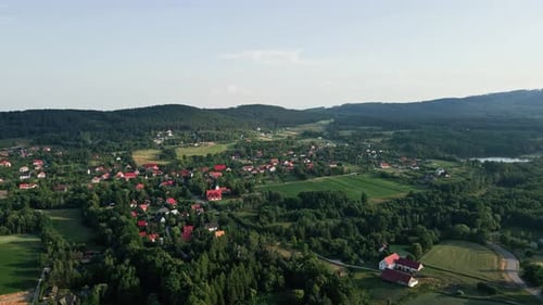 Aerial View of Countryside Area with Village and Mountains