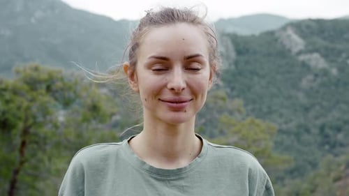Portrait of Beautiful Woman Standing in Front Camera High Green Hills on Background