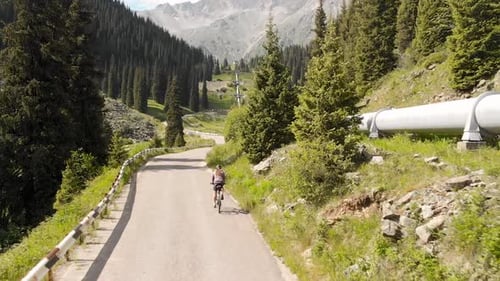 Man Ride Bicycle on the Mountain Road Top View
