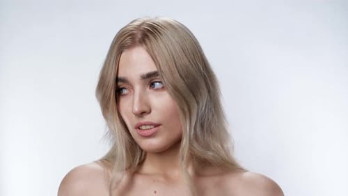 Puzzled Cute Girl Looking at Camera Blonde Sight Close Up White Background .