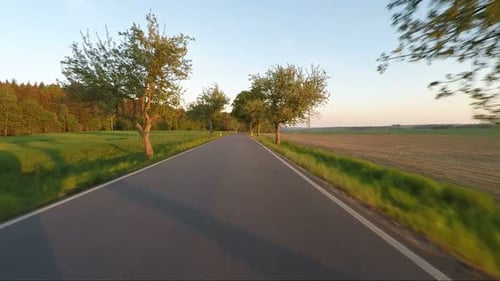 Car driving in spring rural countryside