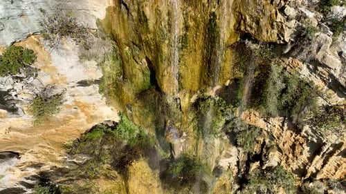 A small waterfall in the mountains aerial view 4 K