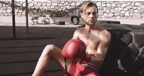 Sweaty Shirtless Boxer Resting With Gloves on