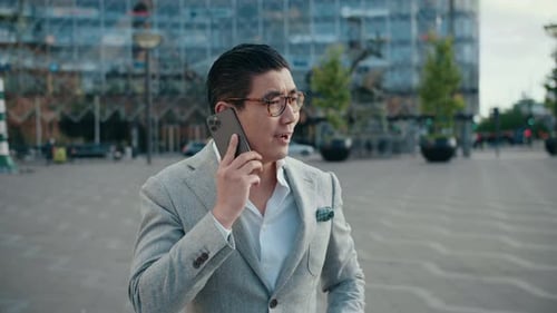 Korean Businessman On Phone Call In City