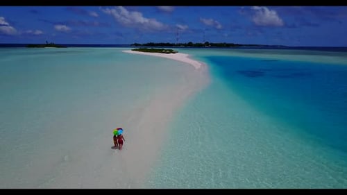 Family of two relax on idyllic coast beach adventure by blue lagoon and white sand background of the
