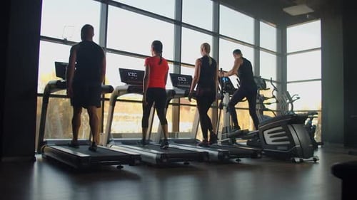 People Exercising on Treadmills at Gym