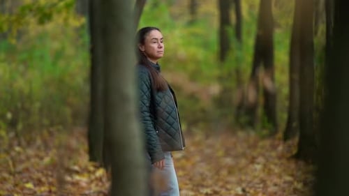 Adult Brunette Lady Is Walking Alone in Picturesque Autumn Forest, Calm and Inspiring Strolling at