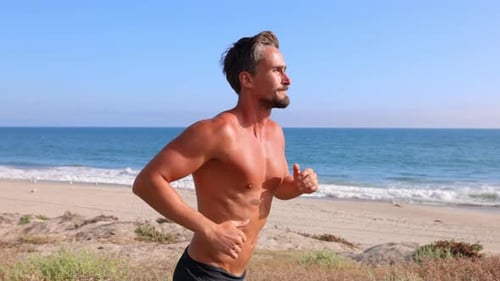 Athletic Man Exercising At The Beach