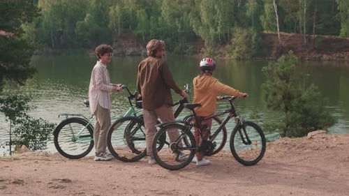 Family Riding On Bicycles In Park