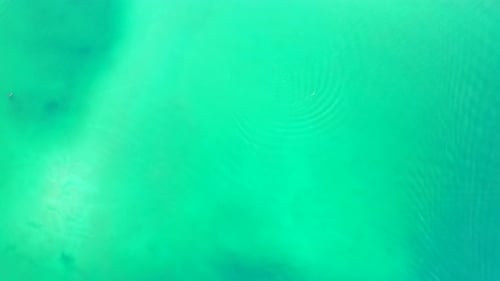 Tropical flying abstract shot of a paradise sunny white sand beach and aqua blue ocean background in