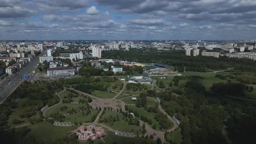 City landscape. Nearby there is a park area. Blue sky with white clouds. Aerial photography.