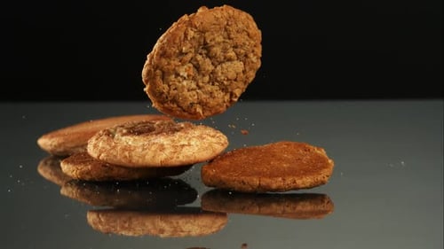 Cookies Falling and Stacking on Reflective Surface